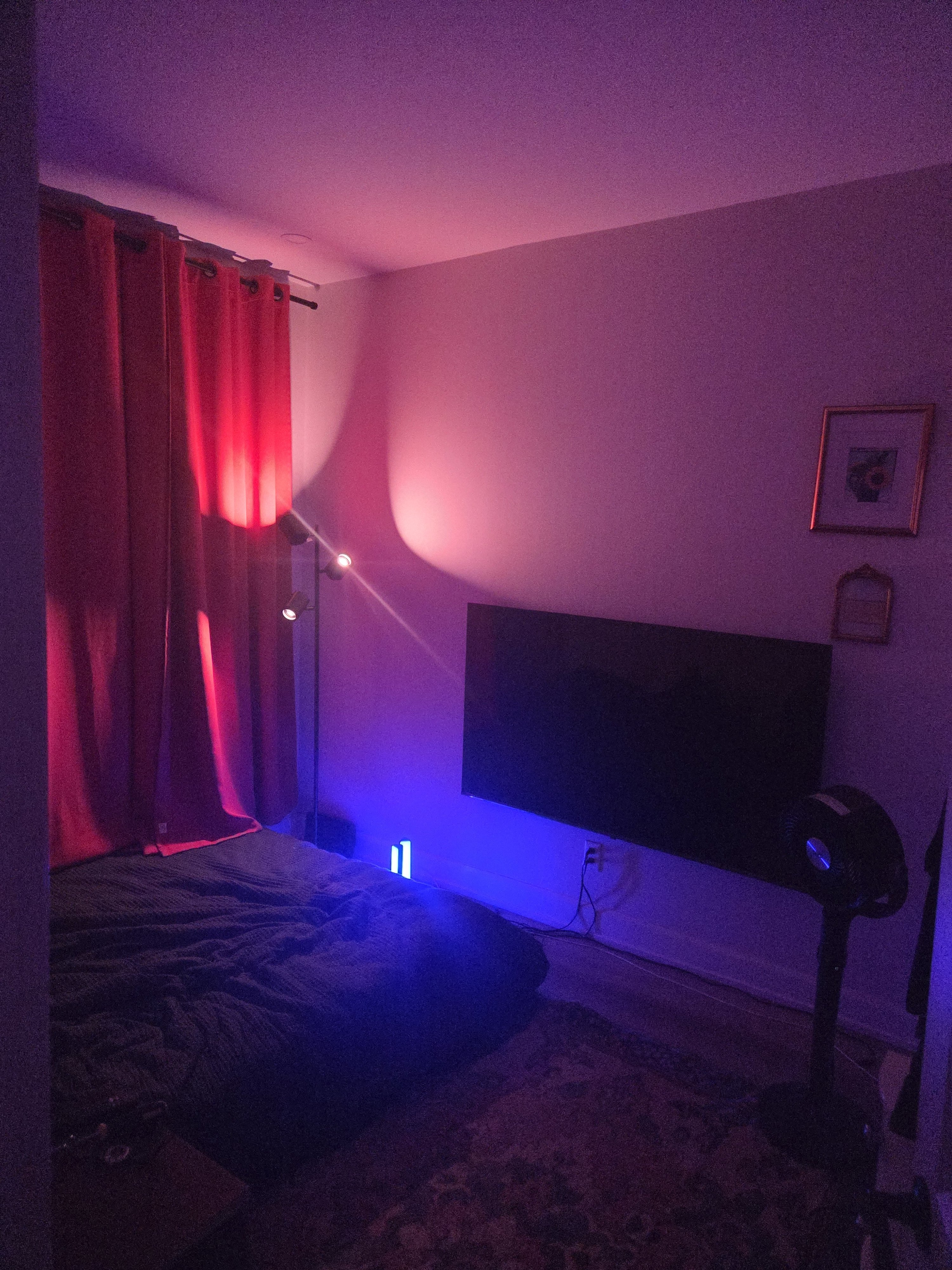 My room lit up in red and blue — new curtains, the TV I mounted myself, new bedding.